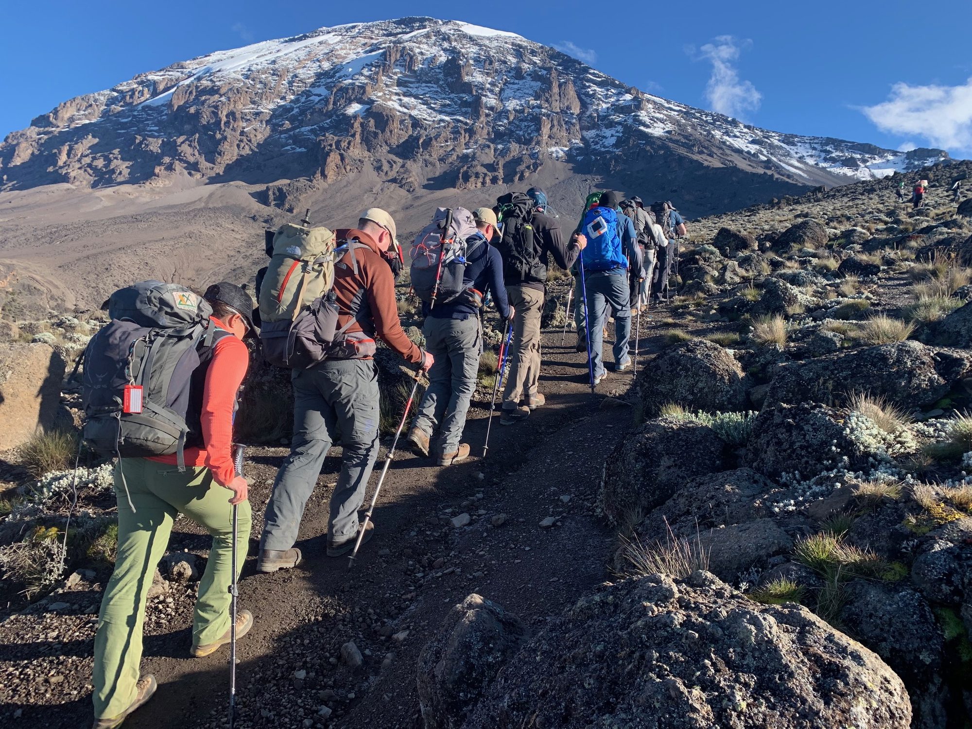 Trekkers hiking the rocky trail on Mount Kilimanjaro